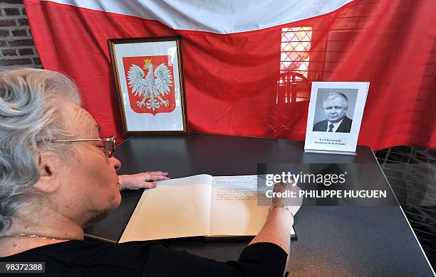 The president of the House Polonia in France Françoise Aghamalian-Konieczna signs a memory book at the Flers Castle in Villeneuve-d'Ascq, northern...