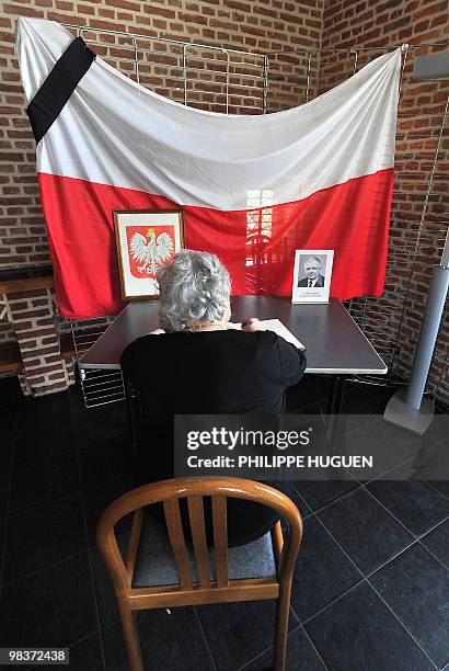 The president of the House Polonia in France Françoise Aghamalian-Konieczna signs a memory book at the Flers Castle in Villeneuve-d'Ascq, northern...