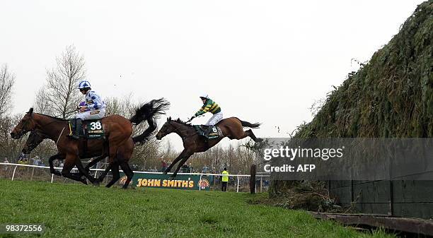 Don't Push It ridden by A P McCoy jumps Beecher's Brook behind Hello Bud ridden by Sam Twiston-Davies before winning The Grand National steeplechase...