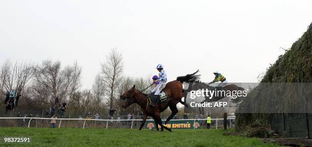 Don't Push It ridden by A P McCoy jumps Beecher's Brook behind Hello Bud ridden by Sam Twiston-Davies before winning The Grand National steeplechase...