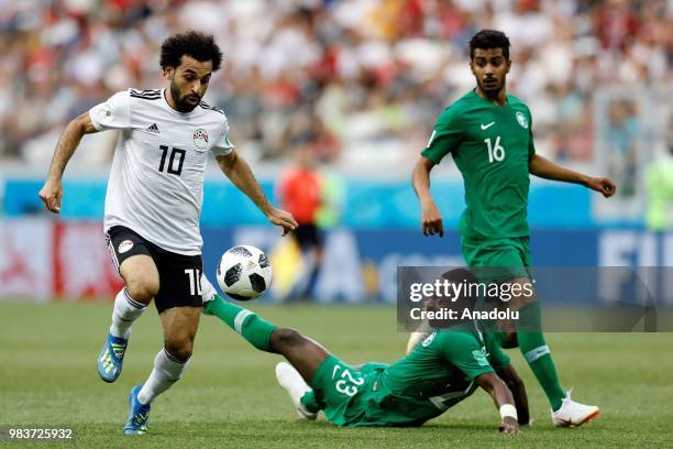 Mohamed Salah of Egypt in action against Motaz Hawsawi of Saudi Arabia during the 2018 FIFA World Cup Russia Group A match between Saudi Arabia and...