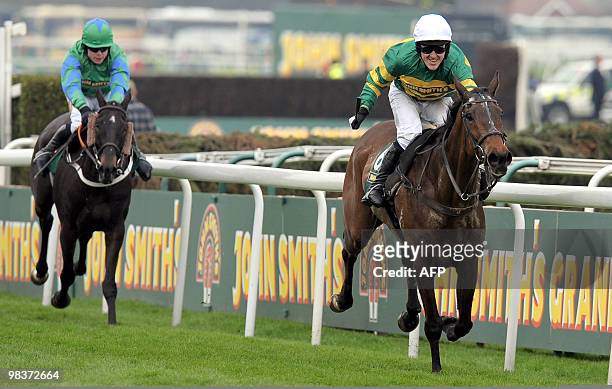 McCoy riding Don't Push It celebrates as he wins the Grand National steeplechase ahead of Black Apalachi ridden by Denis O'Regan at Aintree...