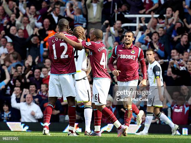 Llan of West Ham United goes back to celebrate with Carlton Cole after scoring during the Barclays Premier League match between West Ham United and...