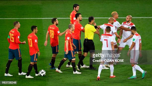 Morocco's forward Noureddine Amrabat is retained by teammates after clashes with Spain's players during the Russia 2018 World Cup Group B football...