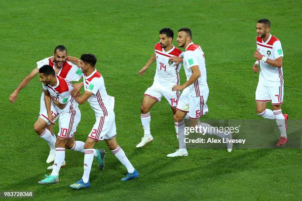 Khalid Boutaib of Morocco celebrates with teammates after scoring his team's first goal during the 2018 FIFA World Cup Russia group B match between...