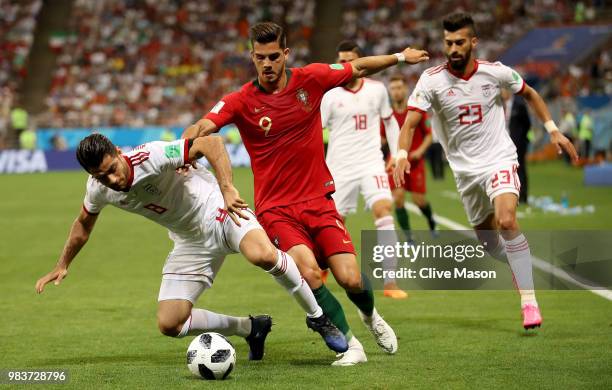 Andre Silva of Portugal is challenged by Ramin Rezaeian and Morteza Pouraliganji of Iran during the 2018 FIFA World Cup Russia group B match between...