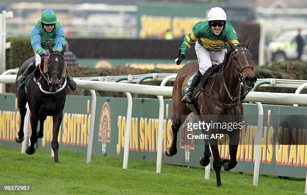 Tony McCoy riding Don't Push It celebrates as he wins the Grand National steeplechase ahead of Black Apalachi ridden by Denis O'Regan at Aintree...