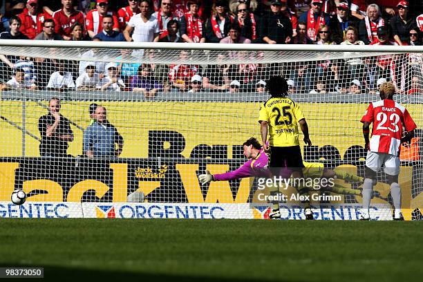 Adam Szalai of Mainz scores his team's first goal against goalkeeper Roman Weidenfeller of Dortmund during the Bundesliga match between FSV Mainz 05...