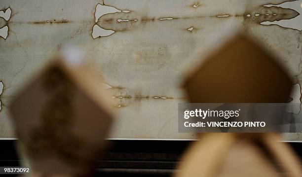 Bishops pray in front of the Shroud of Turin at the end of a mass celebrated by Turin Cardinal Severino Poletto to mark the first day of the display...