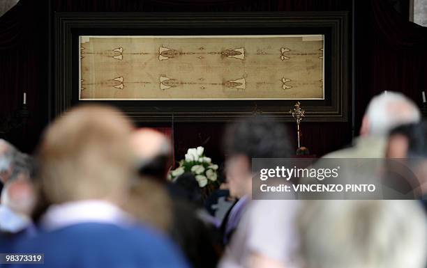 Visitors look at the Shroud of Turin on the first day of its public display in ten years on April 10, 2010 in the Cathedral in Turin. The mysterious...