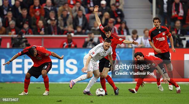 Franck Ribery of Bayern is covered by Leverkusen players during the Bundesliga match between Bayer Leverkusen and FC Bayern Muenchen at BayArena on...