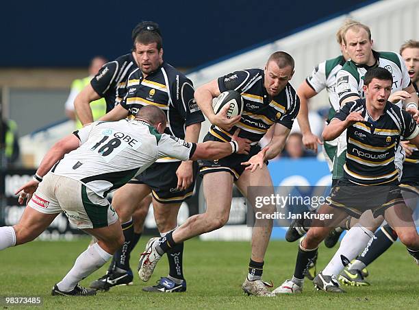 Chris Latham of Worcester is tackled by James Tideswell of London Irish during the Guinness Premiership match between Worcester Warriors and London...