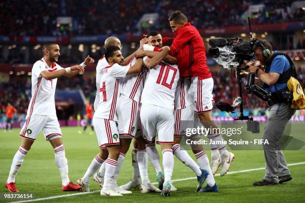 Khalid Boutaib of Morocco celebrates with teammates after scoring his team's first goal during the 2018 FIFA World Cup Russia group B match between...