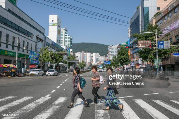 Women cross the main boulevard near Jagalchi Seafood Market on June 24, 2018 in BUSAN, South Korea. Over 66,000 South Koreans have been separated...