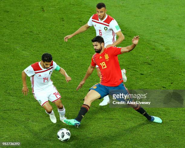 Diego Costa of Spain tackles Mbark Boussoufa of Morocco during the 2018 FIFA World Cup Russia group B match between Spain and Morocco at Kaliningrad...