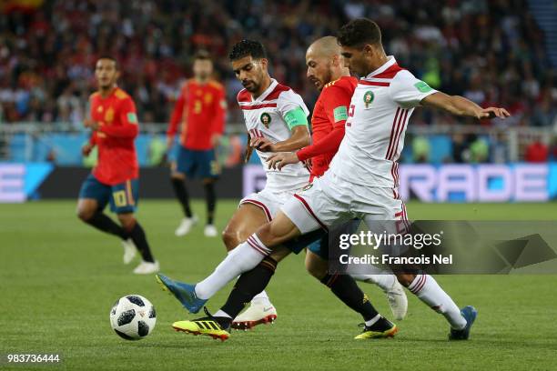 David Silva of Spain is challenged by Mbark Boussoufa of Morocco and Achraf Hakimi of Morocco during the 2018 FIFA World Cup Russia group B match...