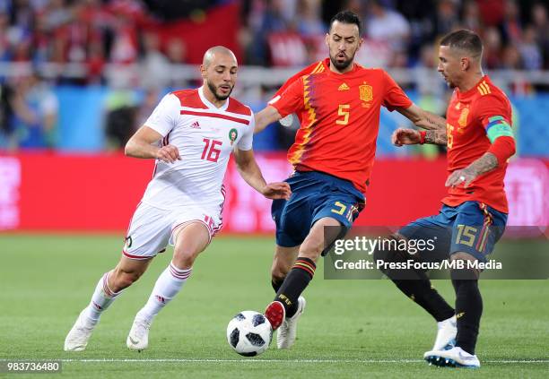 Sergio Busquets of Spain competes with Noureddine Amrabat of Morocco during the 2018 FIFA World Cup Russia group B match between Spain and Morocco at...