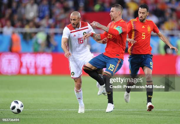 Sergio Ramos of Spain competes with Noureddine Amrabat of Morocco during the 2018 FIFA World Cup Russia group B match between Spain and Morocco at...