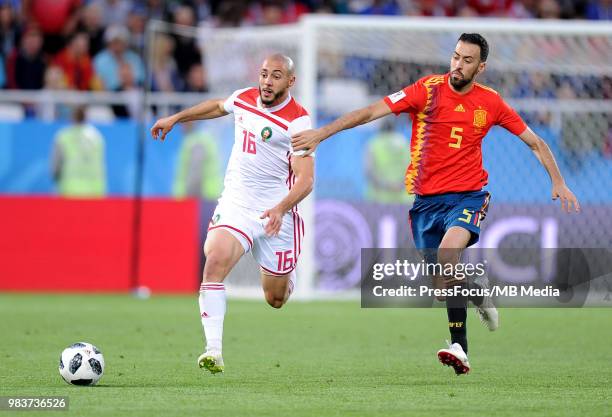 Sergio Busquets of Spain competes with Noureddine Amrabat of Morocco during the 2018 FIFA World Cup Russia group B match between Spain and Morocco at...