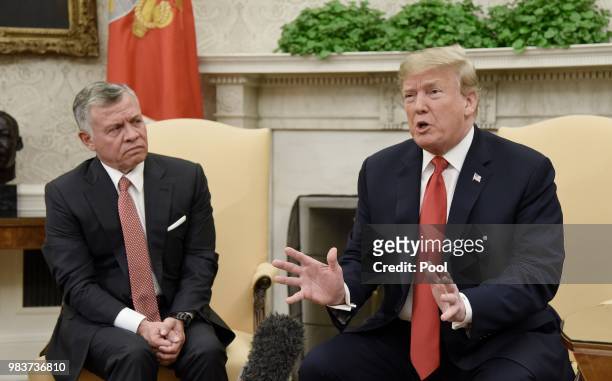 President Donald Trump speaks as King Abdullah II looks on during a meeting in the Oval Office of the White House on June 25, 2018 in Washington, DC.