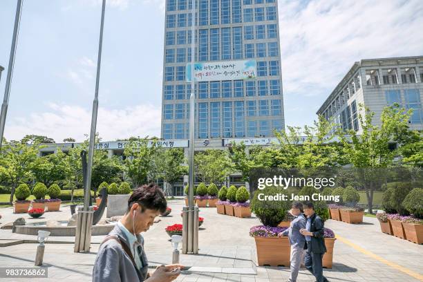 Pedestrians walk in front of Busan City Hall, which used to be a POW camp during the Korean War, on June 23, 2018 in BUSAN, South Korea. Over 66,000...