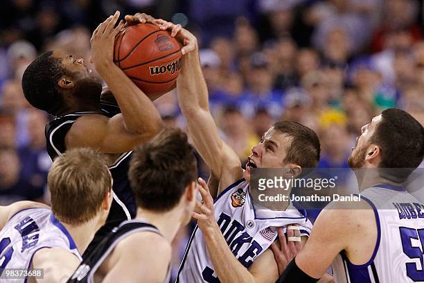 Jon Scheyer of the Duke Blue Devils blocks a shot attempt against the Butler Bulldogs during the 2010 NCAA Division I Men's Basketball National...