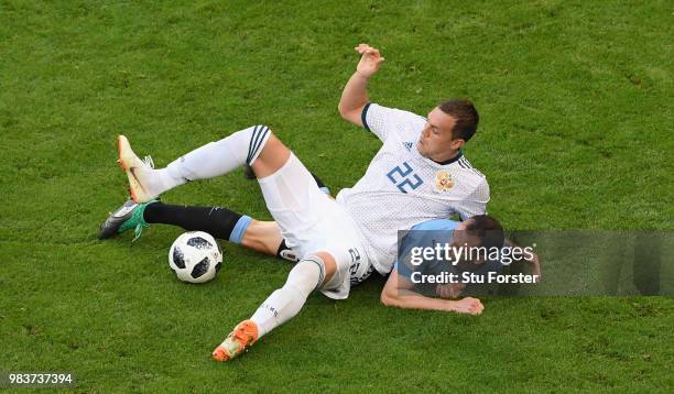 Russia player Artem Dzyuba is challenged by Diego Godin of Uruguay during the 2018 FIFA World Cup Russia group A match between Uruguay and Russia at...