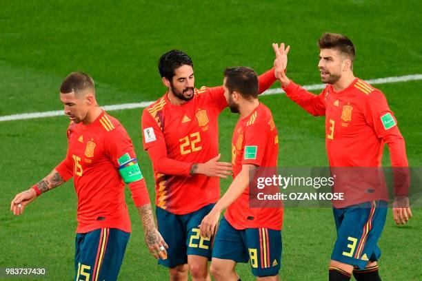 Spain's midfielder Isco celebrates with Spain's defender Sergio Ramos, Spain's defender Jordi Alba and Spain's defender Gerard Pique after scoring...