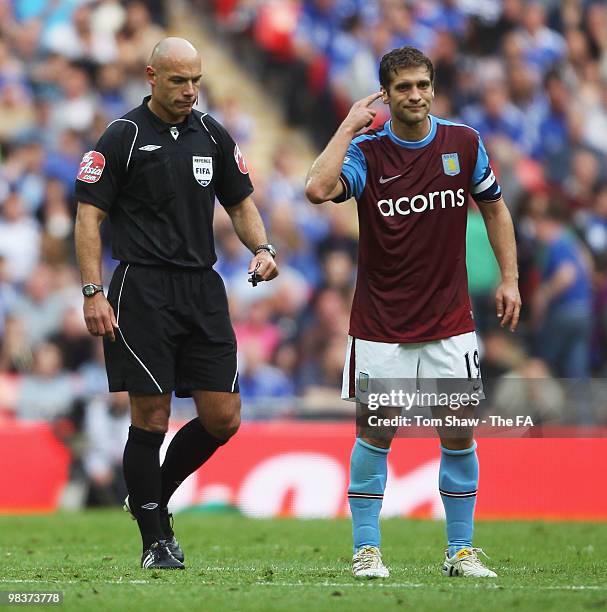 Stiliyan Petrov of Aston Villa gestures as referee Howard Webb looks on during the FA Cup sponsored by E.ON Semi Final match between Aston Villa and...