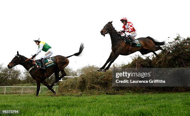Cloudy Lane ridden by Jason Maguire and Nozic ridden by Liam Treadwell clear the Open Ditch during the John Smiths Grand National at Aintree...
