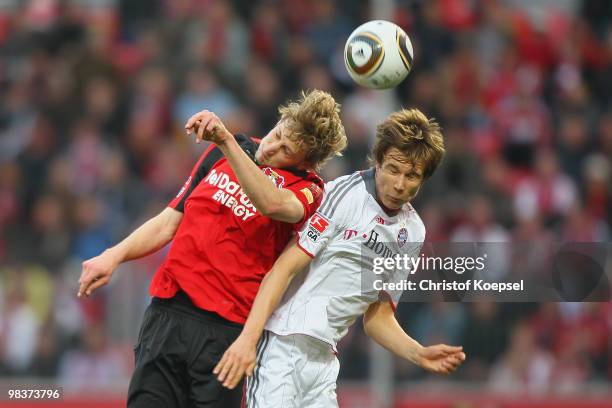 Stefan Kiessling of Leverkusen and Holger Badstuber of Bayern go up for a header during the Bundesliga match between Bayer Leverkusen and FC Bayern...