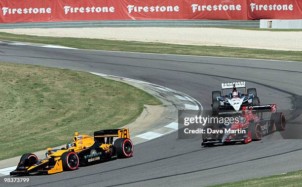 Simona De Silvestro of Switzerland, driver of the Team Stargate Worlds HVM Dallara Honda leads a pack of cars through turn 11 during qualifying for...