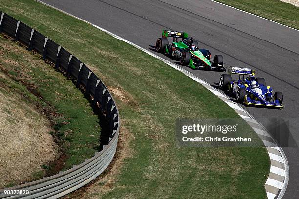 Mike Conway of England, driver of the Dreyer & Reinbold Racing Dallara Honda leads Danica Patrick driver of the Team GoDaddy.com Andretti Autosport...