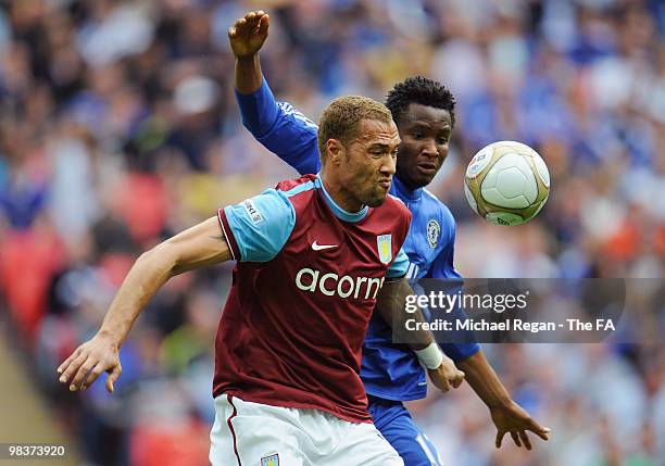 John Carew of Aston Villa holds back Jon Obi Mikel of Chelsea during the FA Cup sponsored by E.ON Semi Final match between Aston Villa and Chelsea at...