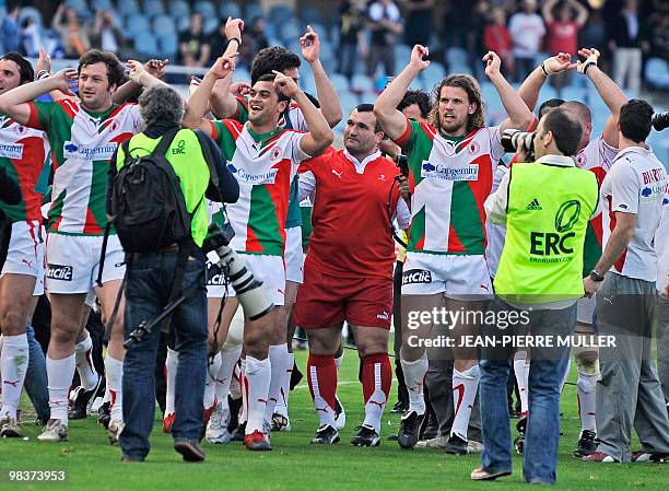 Biarritz's coach Jean-Michel Gonzalez celebrates with players after their European Cup quarter final victory over Neath-Swansea's Ospreys at the...