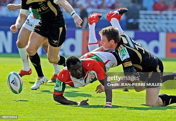 Biarritz's wing Takudzwa Ngwenya vies with Ospreys' Mike Phillips during their European Cup quarter final match Biarritz-Neath-Swansea's Ospreys at...