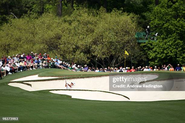 Adam Scott of Australia plays from a bunker on the first hole during the third round of the 2010 Masters Tournament at Augusta National Golf Club on...