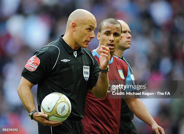 Gabriel Agbonlahor of Aston Villa speaks with referee Howard Webb as they walk off the pitch at half time during the FA Cup sponsored by E.ON Semi...