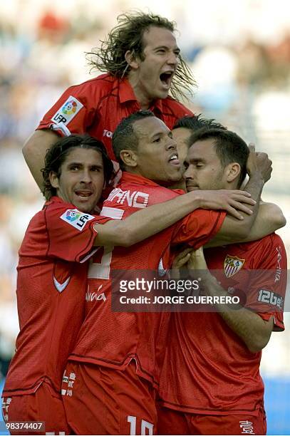 Sevilla's defender Lolo celebrates with teammates Diego Capel , Luis Fabiano and Julien Escude after scoring against Malaga during a Spanish league...