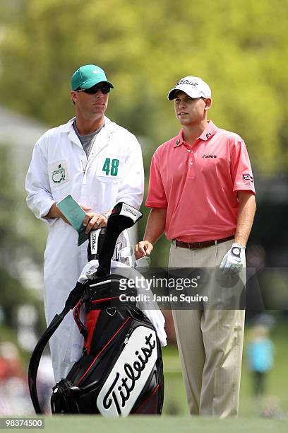 Bill Haas waits with his caddie Michael Maness on the first hole during the third round of the 2010 Masters Tournament at Augusta National Golf Club...