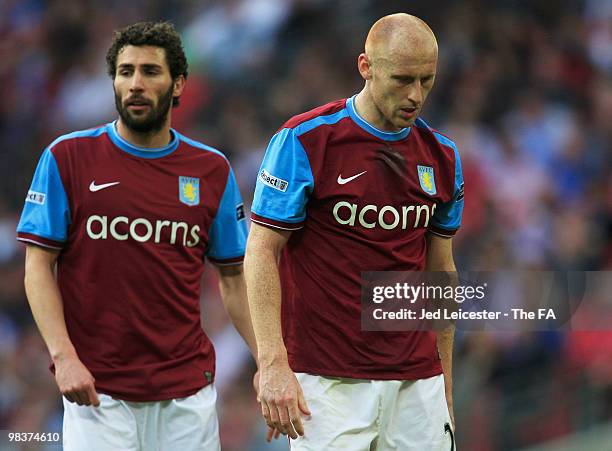 Carlos Cuellar and James Collins of Aston Villa walk slowly off the pitch dejected after defeat in the FA Cup sponsored by E.ON Semi Final match...