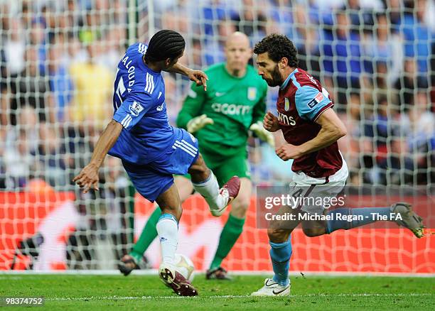 Carlos Cuellar of Aston Villa attempts to block the shot by Florent Malouda of Chelsea as he scores the second goal during the FA Cup sponsored by...