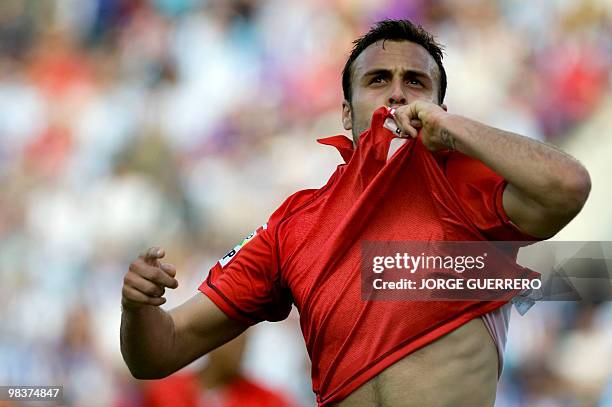 Sevilla's defender Juan Cala celebrates after scoring against Malaga during a Spanish league football match at the Rosaleda stadium in Malaga on...