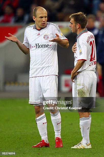 Arjen Robben of Bayern and Philipp Lahm of Bayern look thoughtful during the Bundesliga match between Bayer Leverkusen and FC Bayern Muenchen at the...