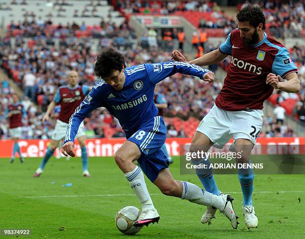 Chelsea's Yury Zhirkov runs past Aston Villa's Aston Villa's Carlos Cuellar during the FA Cup semi-final football match at Wembley Stadium in London...