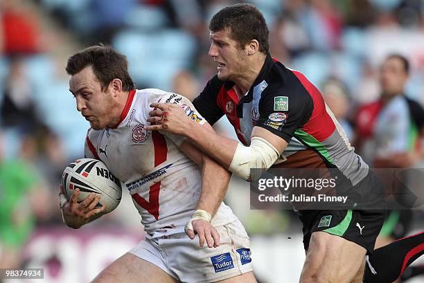 James Roby of St Helens is tackled by Toby Clubb of Quins during the Engage Super League match between Harlequins and St Helens at The Stoop on April...