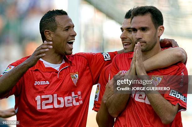 Sevilla's defender Lolo celebrates with teammates Sevilla's Brazilian forward Luis Fabiano and Sevilla's midfielder Alvaro Negredo after scoring...