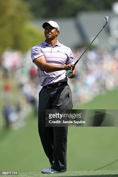 Tiger Woods watches his approach shot on the first hole during the third round of the 2010 Masters Tournament at Augusta National Golf Club on April...