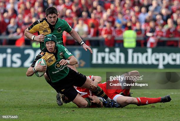 Bruce Reihana of Northampton is tackled by Jean de Villiers during the Heineken Cup quarter final match between Munster and Northampton Saints at...