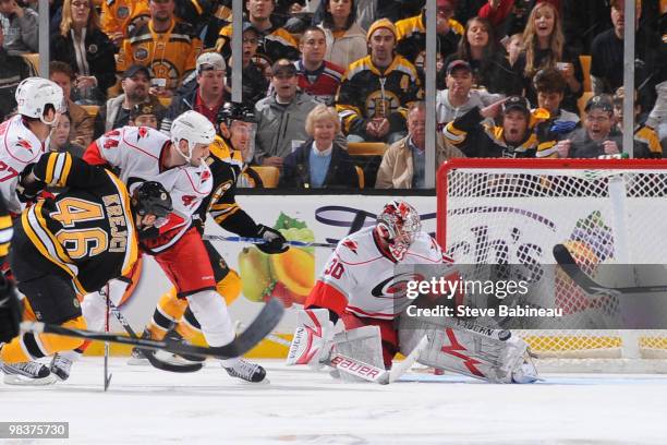 David Krejci of the Boston Bruins takes a shot against Cam Ward of the Carolina Hurricanes at the TD Garden on April 10, 2010 in Boston,...